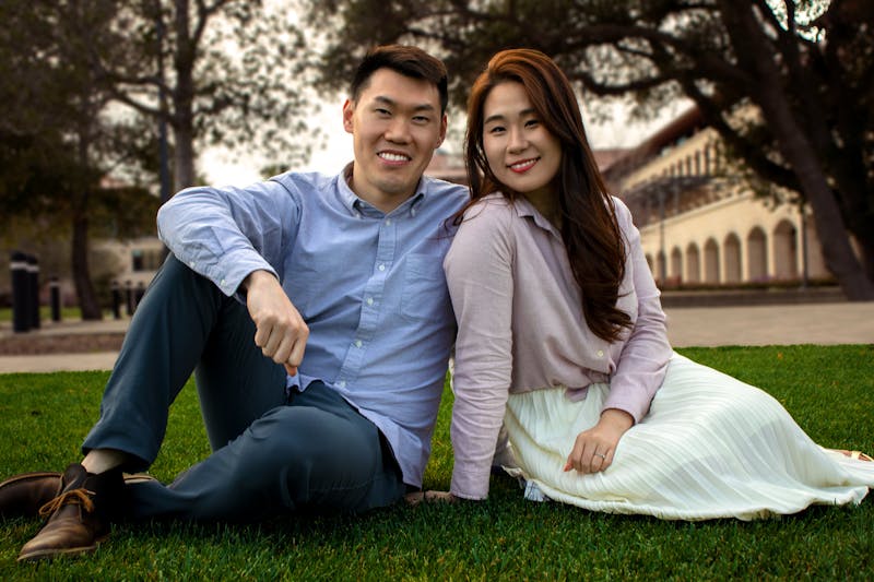 A couple sitting on the grass at Stanford University